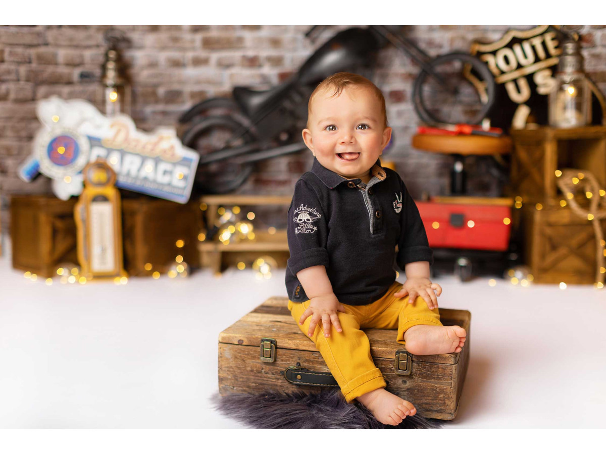 Baby & cake smash photo backdrop Bickers – brick wall with vintage motorcycle and garage signs | Colors&Drops