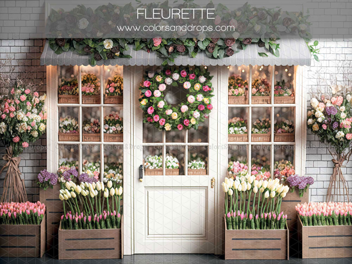 Fond photo de printemps Fleurette – devanture de fleuriste en brique blanche avec couronne et tulipes | Colors&Drops